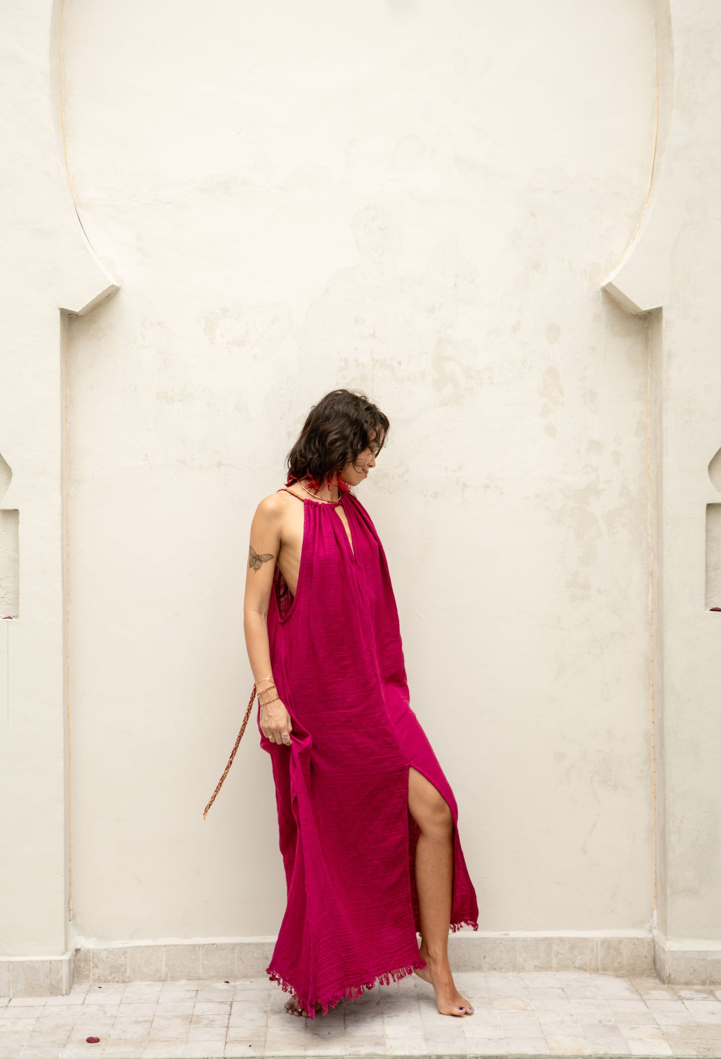 detail of golden Eri silk braids and charms on the Delphi Dress